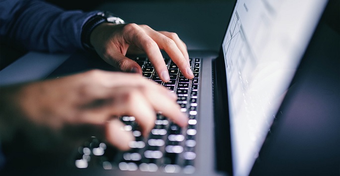 typing at computer keyboard