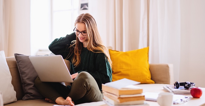 student using laptop at home