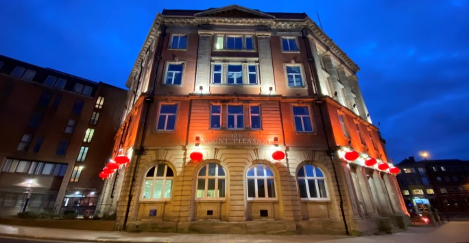 An old building with red lanterns at night