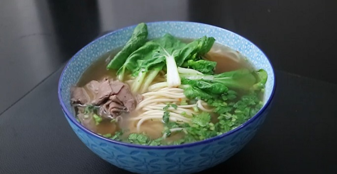 still from a recipe video showing how to make beef noodles