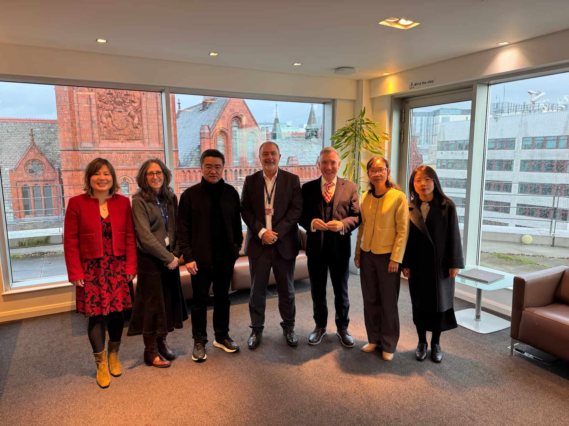 Dr penny Ding, Professor Georgina Endfield, Professor WEN Guangrui, Professor Gavin Brown, Gary millar, Liu Hao and Ms Min Dan stood in the Foundation Building with the VG&M in the background.