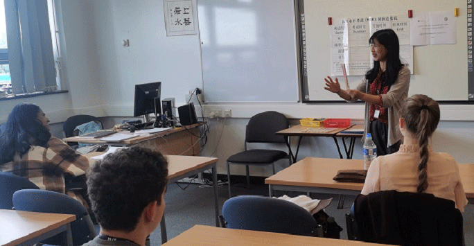 A female Chinese teacher with college students