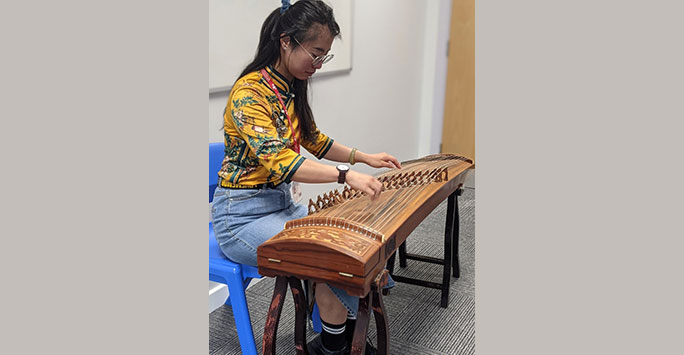 Music Teacher Xiaoxiao Hou demonstrating Chinese music on the Guzheng