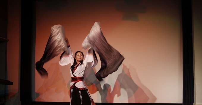 Confucius Institute teacher Yuqiao Cai performing Chinese fan dance 