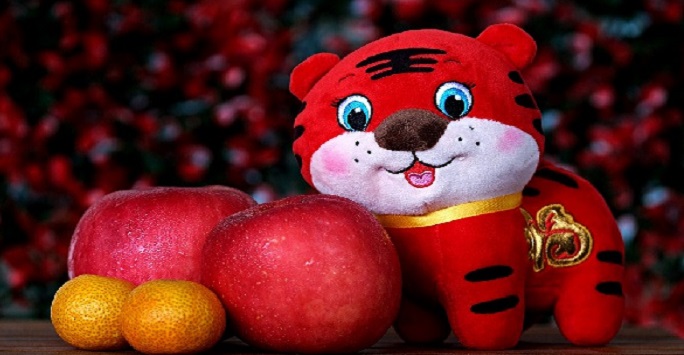 a stuffed tiger with fruit
