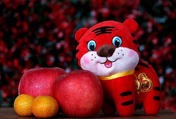 A tiger plush toy and some fruit