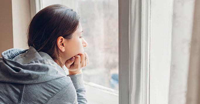 Woman looking out of window