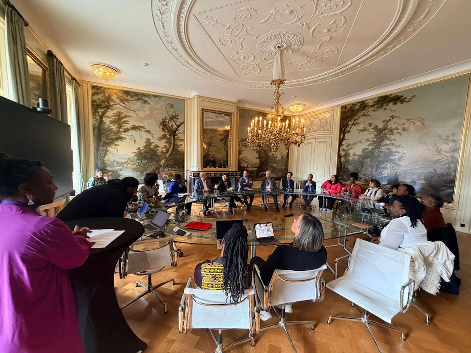 People sat around a round table for the third UNESCO International Dialogue for Reparatory Justice