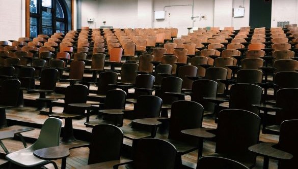 An empty conference room with chairs and desks