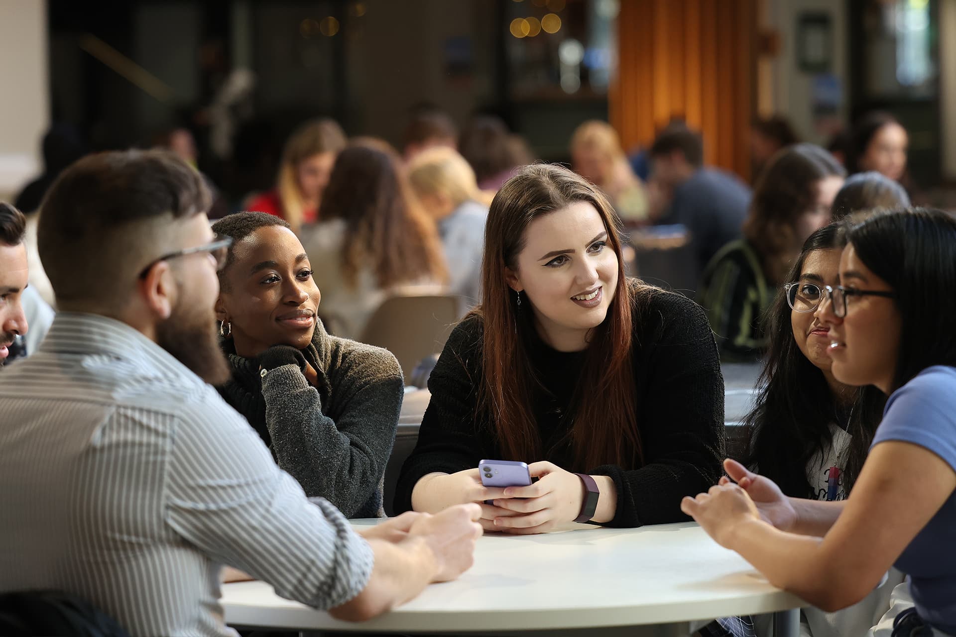 Students sitting at a table together in the Guild