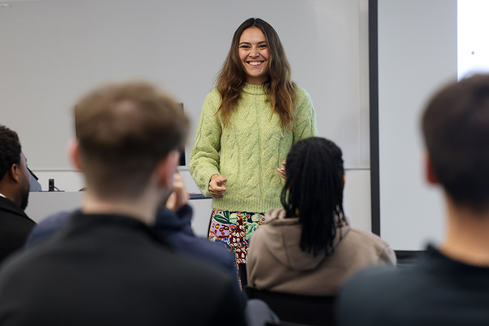 Student standing up in front of a seminar group