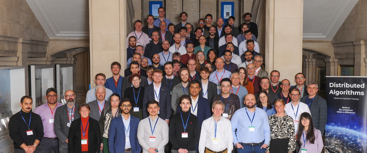 An image of members of the signal processing group stood on different levels of a stone staircase