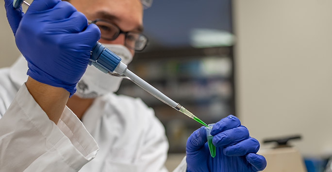 Scientist preparing a sample with pipette