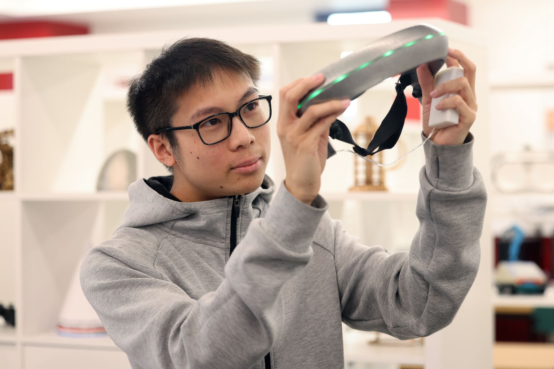 A Product Design Student holding optical device