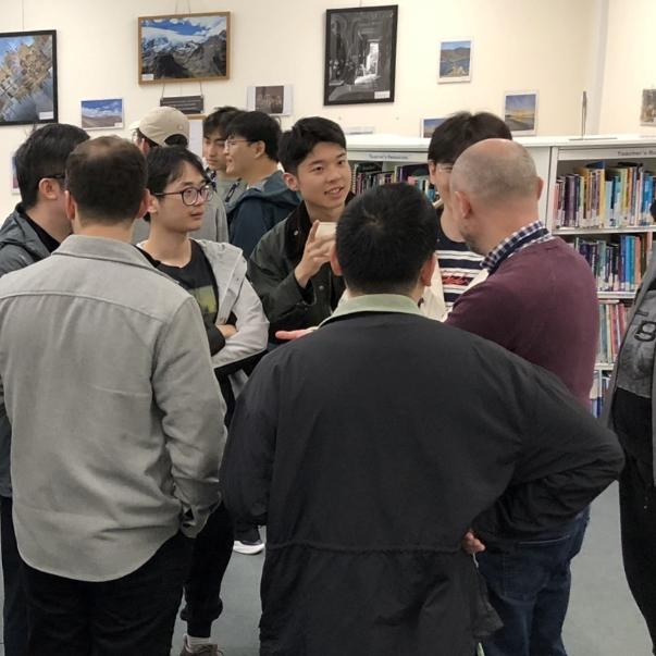 A group of students chat during a social event at the Language Lounge