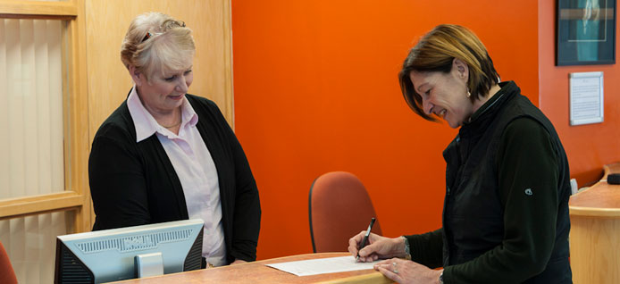 Client being welcomed at the Equine Hospital reception desk