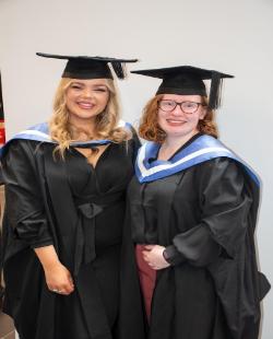 Bethany blackford Jones and Ellen Bootes  - students in graduation gowns