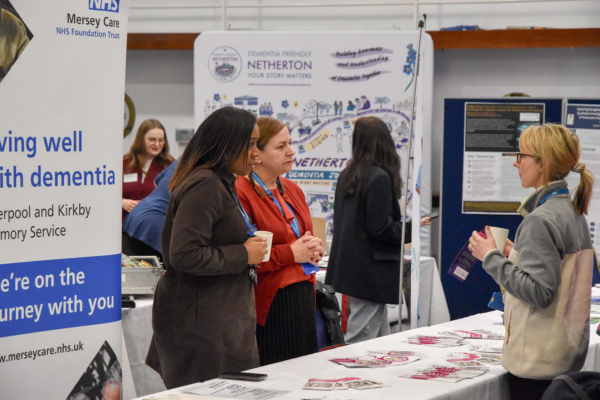 Delegates attend the Annual Dementia Conference, watching the speaker at a podium