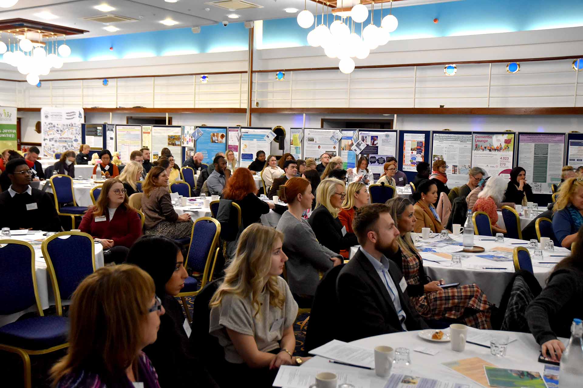 Delegates attend the Annual Dementia Conference, watching the speaker at a podium