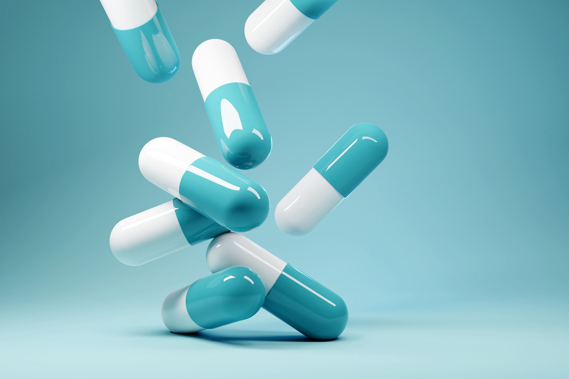 Image of a handful of pills falling onto a counter.