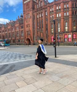 Libby MacClaren in graduation gown outside Victoria Gallery and Museum