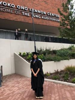 Graduate standing outside the Yoko Ono Lennon Centre