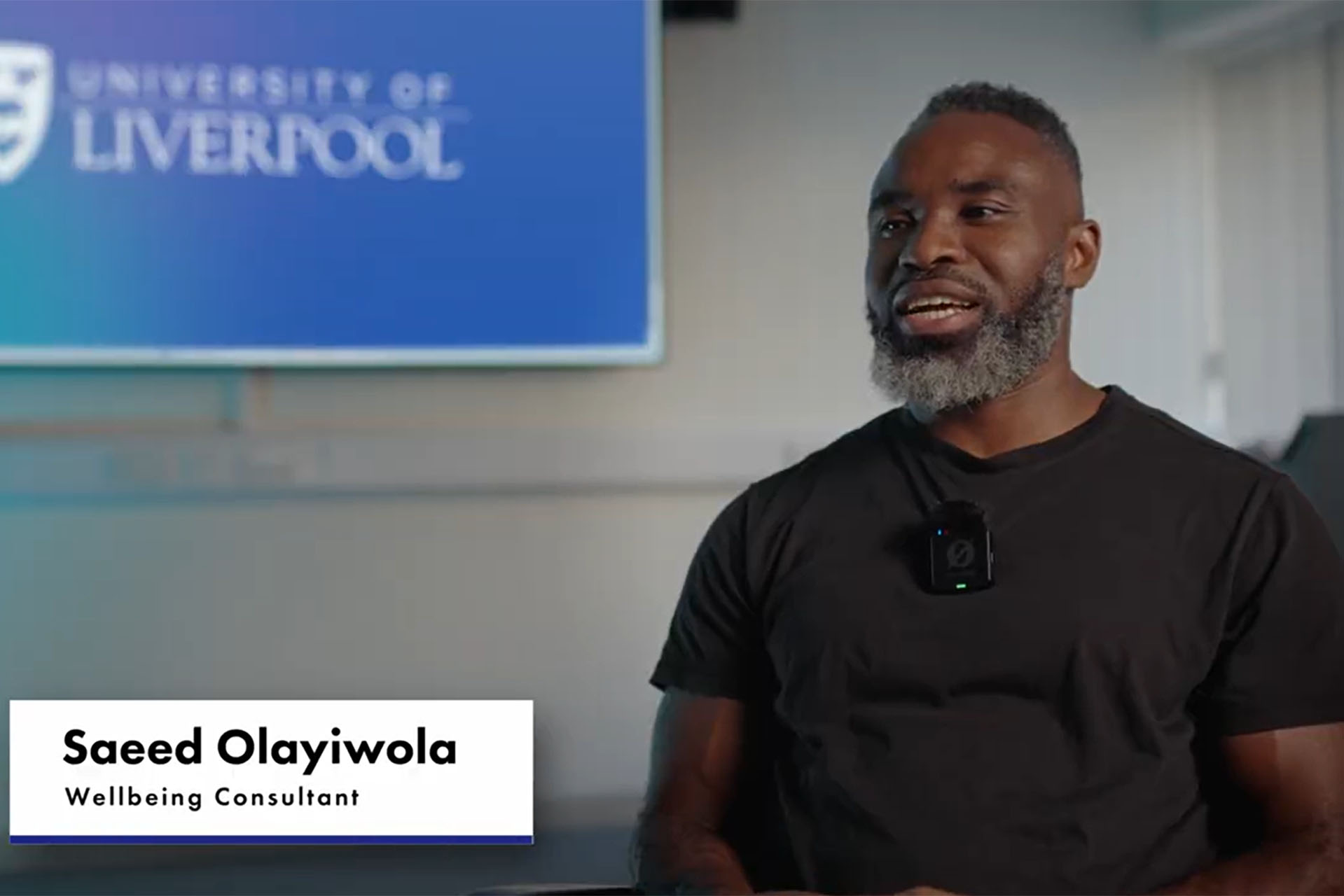 Screenshot of mentee describing their experiences taking part in the mentorship scheme. Saeed Olayiwola sat in front of a screen displaying the university of liverpool logo