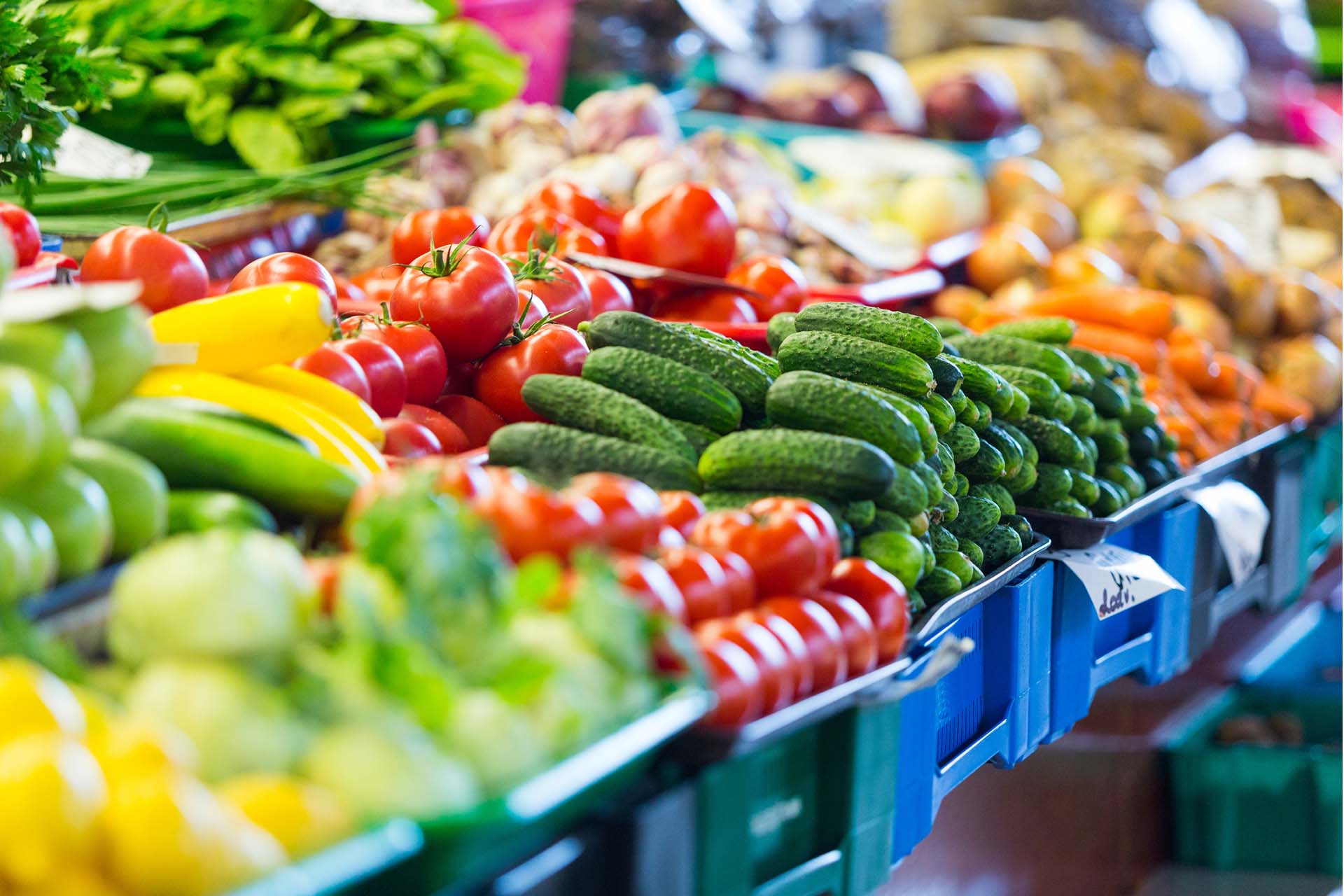 image of fruit and veg stacked up in a market