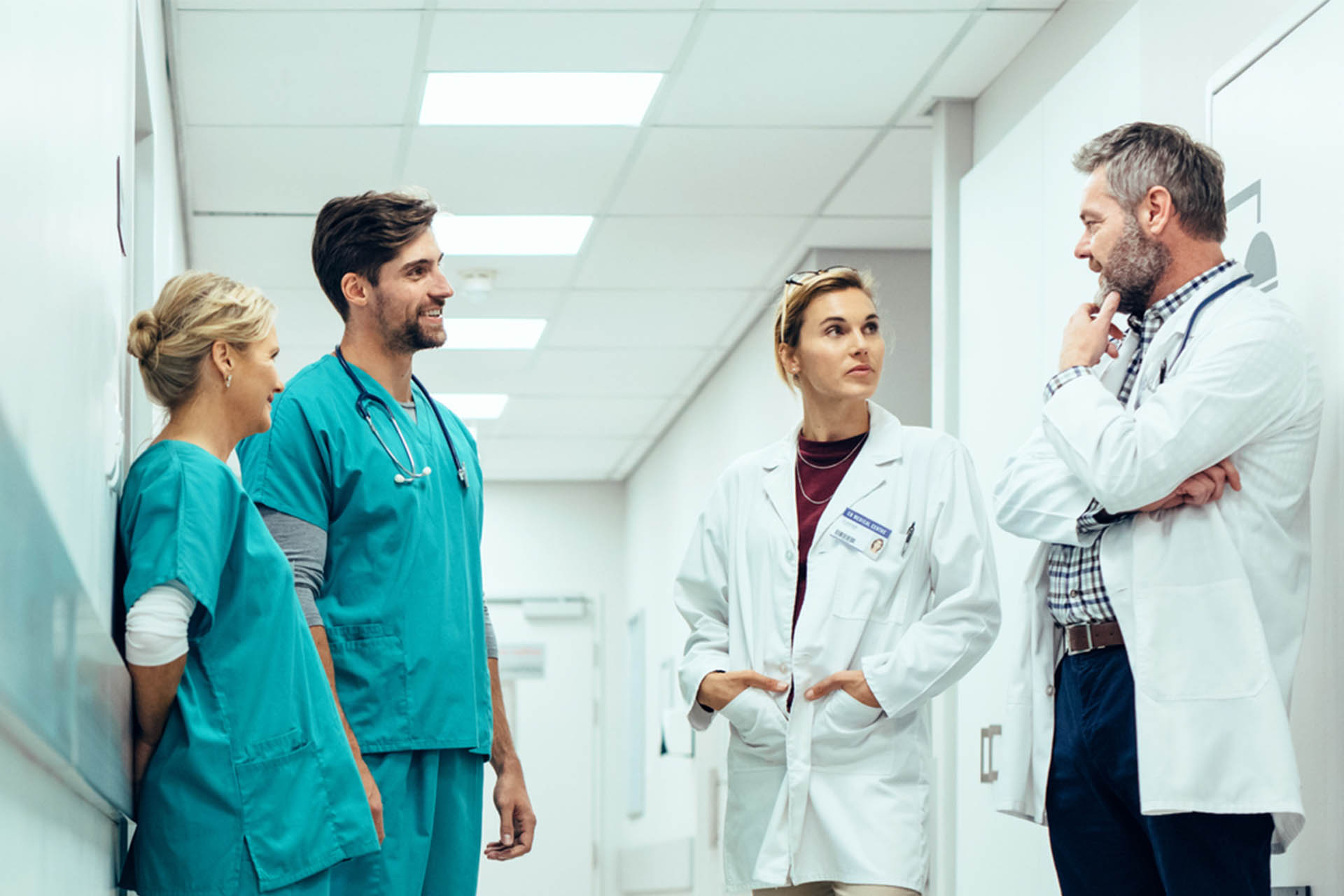 Group of doctors talking in hopsital corridor