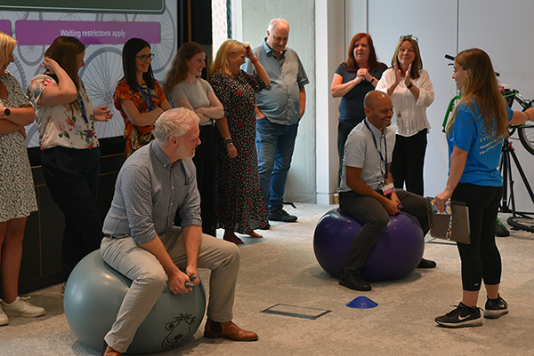 staff taking part in space hopper race