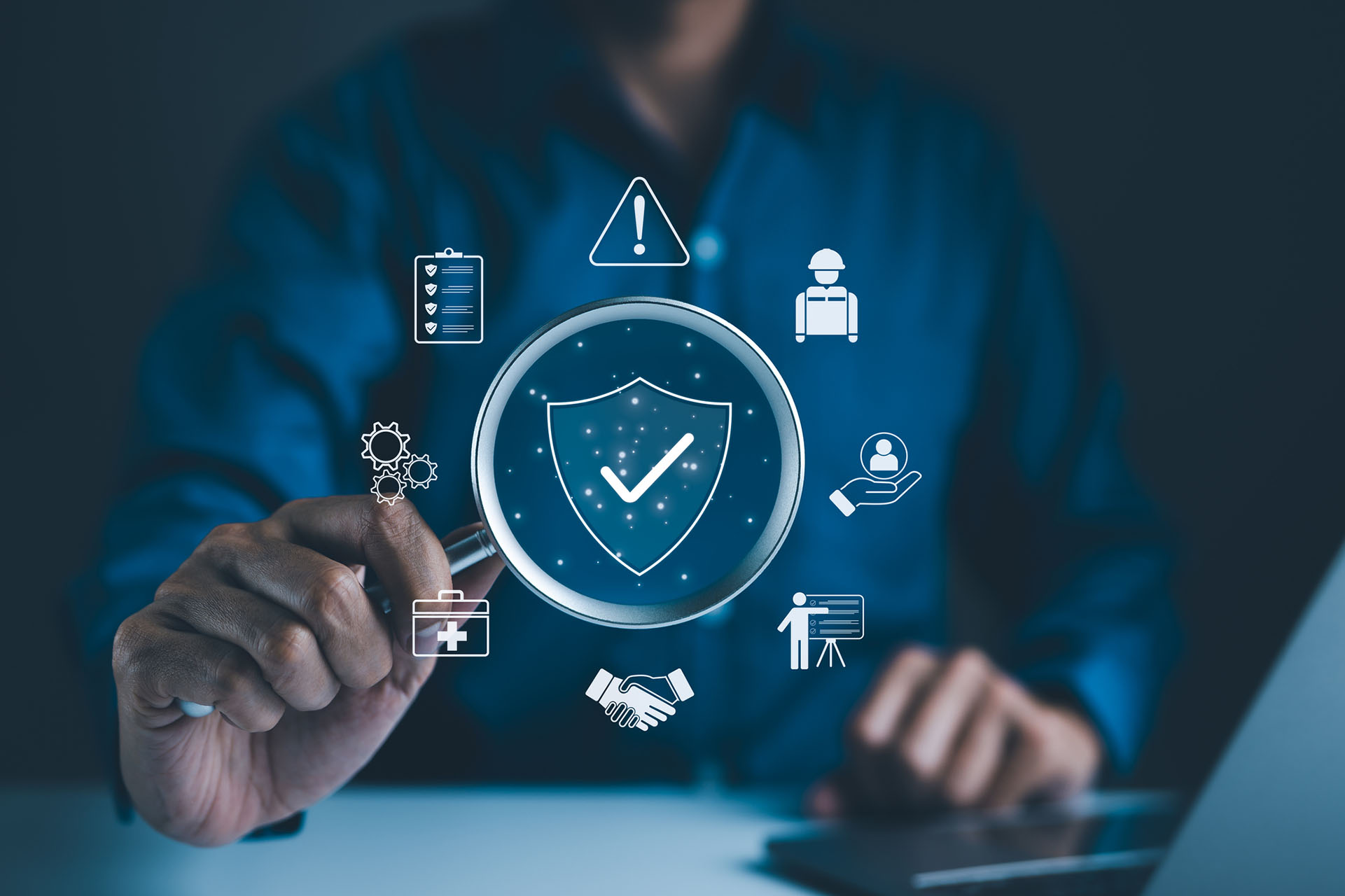 image of a scientist sitting at a desk interacting with a projected graphic of various different information streams