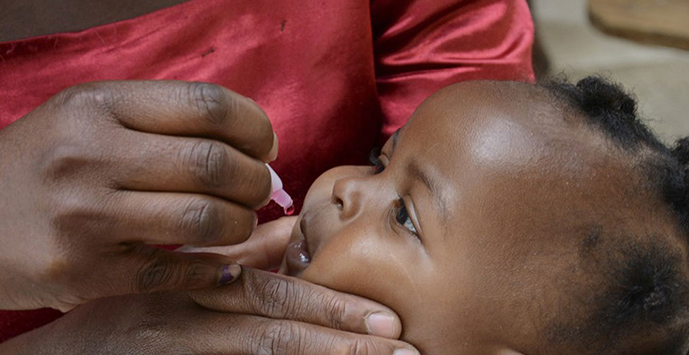 A baby receiving an oral vaccination.