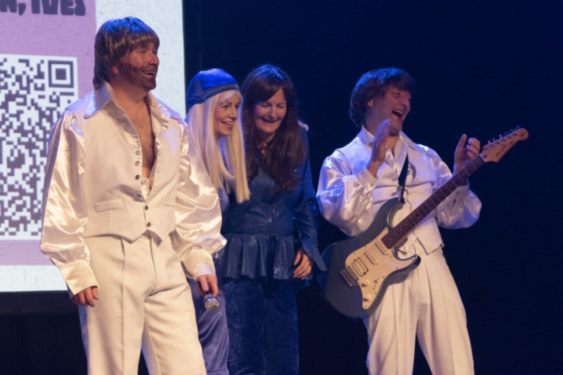 HLS leadership team dressed as the band ABBA for a charity talent show