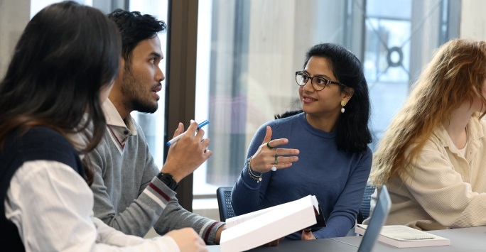 Three students chatting and studying