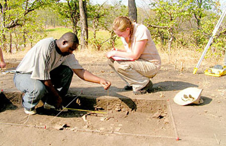 People measuring an area of soil