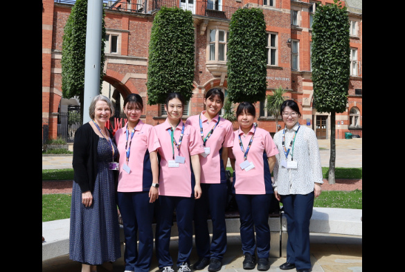 The Japanese visitors standing on campus with Alison Marchbank