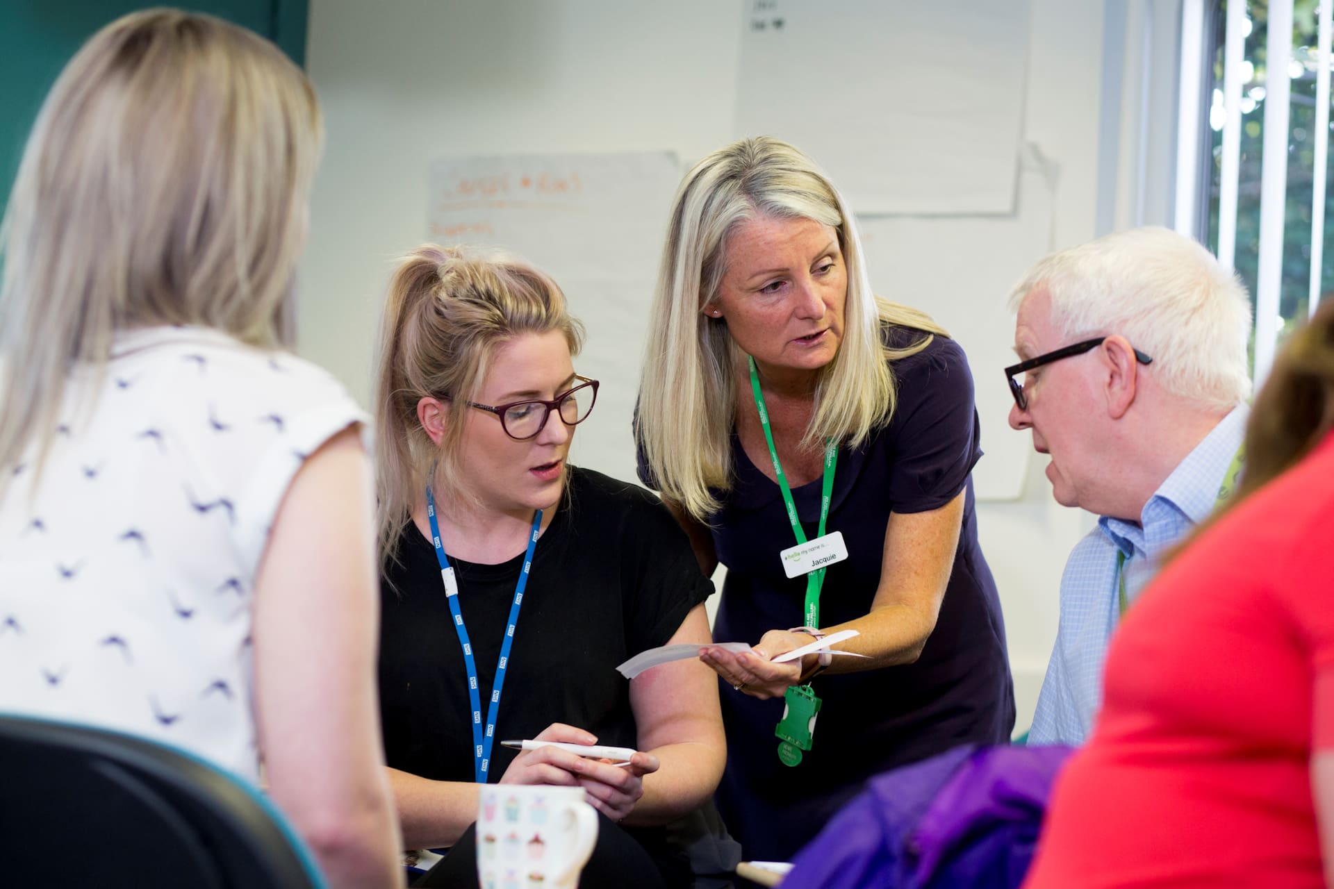 A small group of healthcare workers undertaking a joint task in a training session.