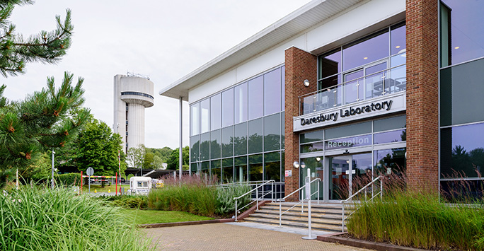 Main entrance of glass-fronted building with sign saying Daresbury Laboratory