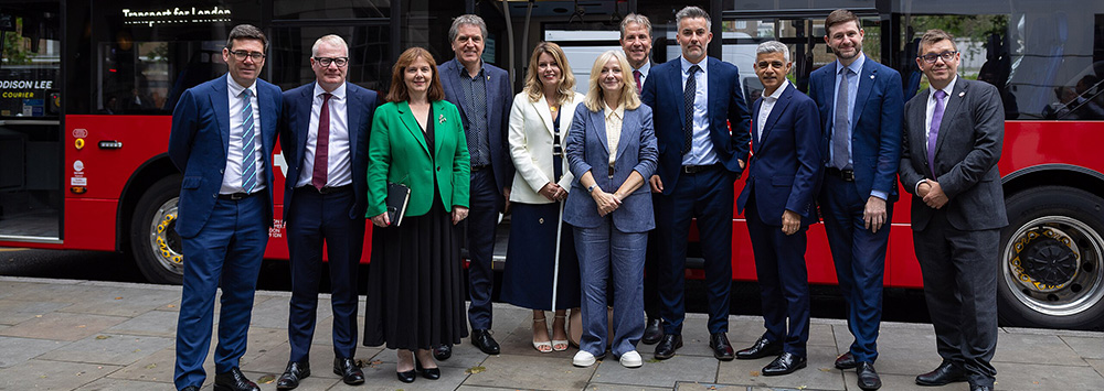 Minister of State at the Ministry of Housing, Communities and Local Government, Jim McMahon and the regional mayors in front of a red Transport for London electric bus