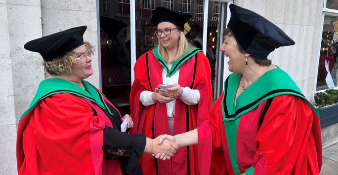 CHES Graduates congratulating one another on Graduation day outside Philharmonic Hall