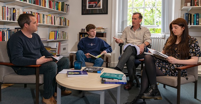 Irish Studies students and lecturer discussing books