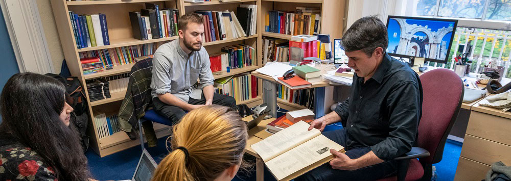 Staff and students in discussion in an office