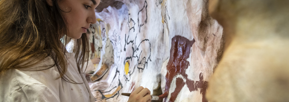Student taking part in cave painting