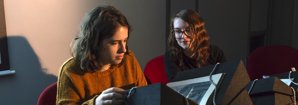 Two students looking at a book in the Special Collections and Archives