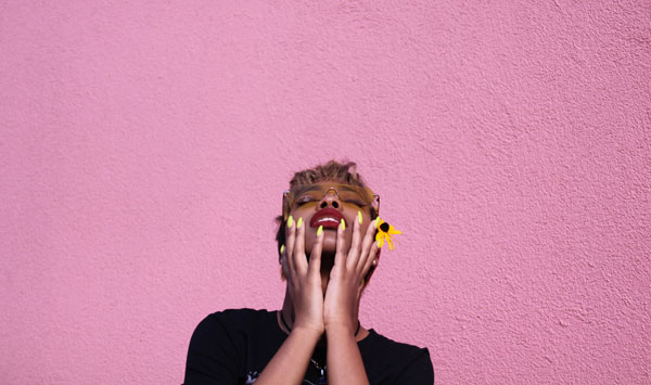 Woman holding her face and looking up