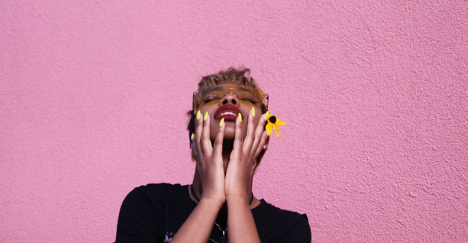 Woman holding her hands up to her face