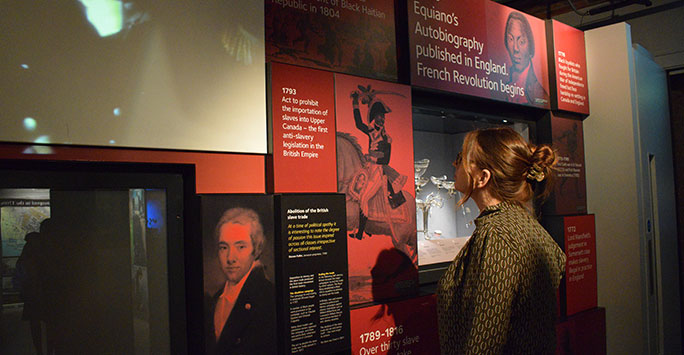 Woman looking at display in International Slavery Museum