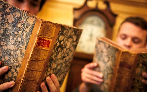 Students looking through book