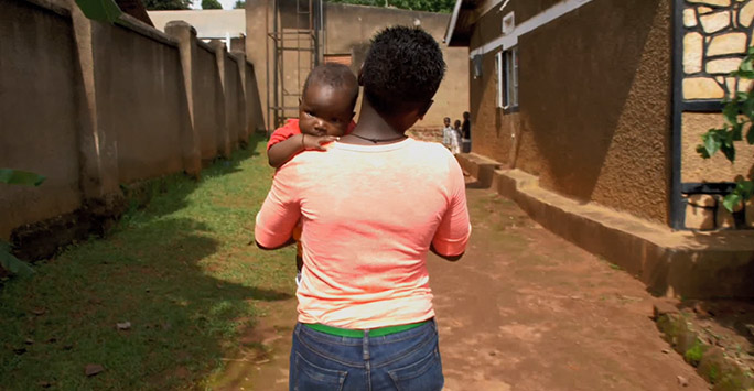 Mother walking carrying baby