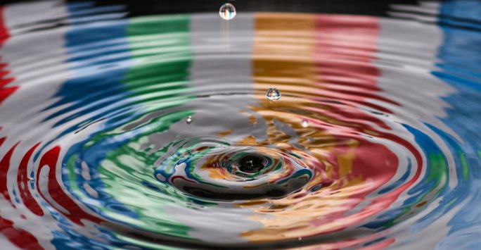 Various colours reflected in a water ripple